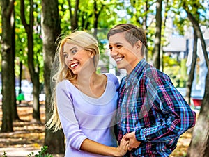 Young couple hugging and flirting in park