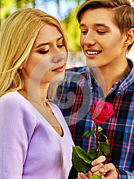 Young couple hugging and flirting in park.