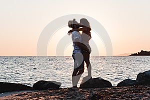Young couple hugging and kissing on a beach