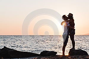 Young couple hugging and kissing on a beach