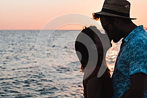 Young couple hugging and kissing on a beach