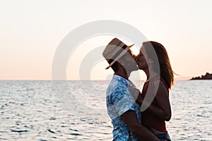 Young couple hugging and kissing on a beach