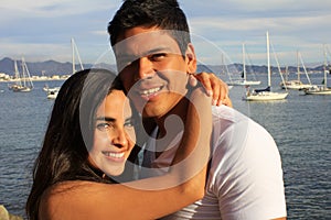 Young couple hugging by the ocean