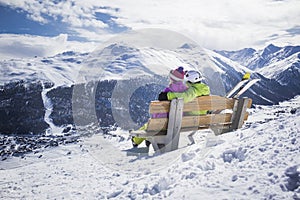 Young couple hugging ski resort winter mountains