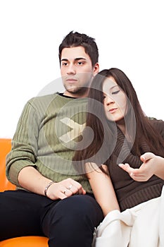 Young couple hugging on sofa at home