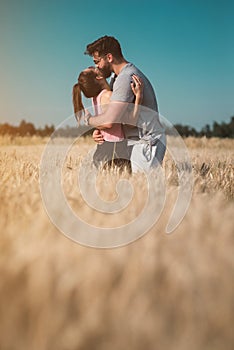 Young couple hugging in the wheat field