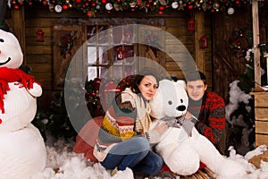 Young Couple Hugging White Winter Bear Doll