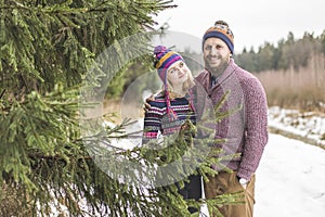 Young couple hugging in winter forest