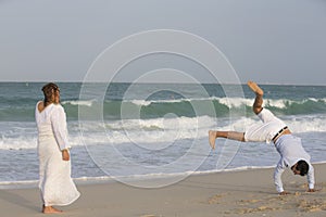 Young couple hving fun on at the beach in Dubai