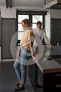 Young couple ignoring each other after having argument in kitchen