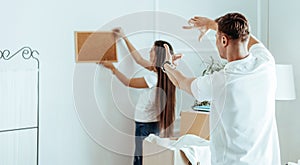 Young couple inventing the interior of their new apartment .