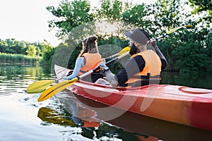 Young couple kayaking on river