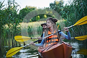Young couple kayaking on river