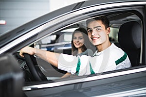 Young couple with keys to new car