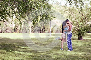 Young couple kissing in a beautiful park