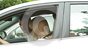 Young couple kissing in the car. Man and woman riding in the car