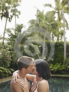 Young Couple Kissing In Garden