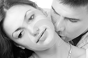 Young couple kissing isolated on white