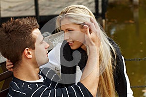 Young couple kissing by lake