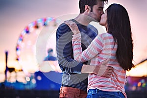 Young couple kissing near santa monica pier