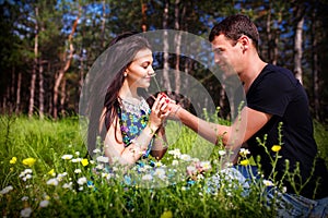 Young couple kissing outdoor in summer sun light. Kiss love date color evening teen.