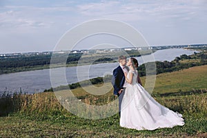 Young couple kissing outdoors on their wedding day