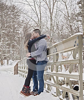 Young couple kissing outdoors in winter