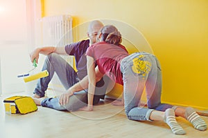 Young couple kissing after painting the room