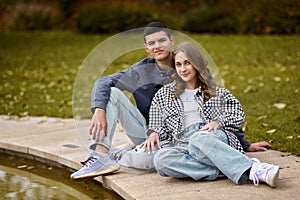 Young couple kissing and rejoices at the lake. lovely young couple kissing outdoors in autumn. Loving couple walking in
