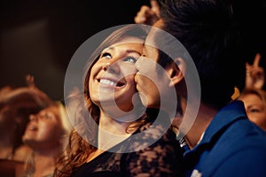 A young couple kissing at a rock concert. This concert was created for the sole purpose of this photo shoot, featuring