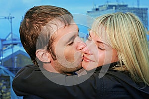 Young couple kissing on roof