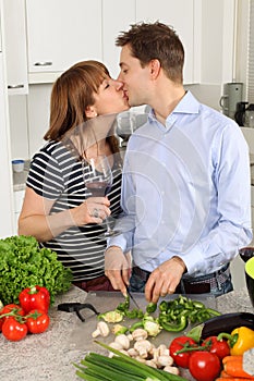 Young couple kissing in their kitchen
