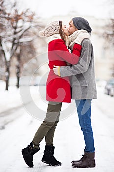Young couple kissing on winter day