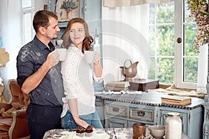 Young couple in the kitchen playing with flour. Funny moments, smiles, cooking, Happy together, memories.