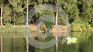 Young couple on a lake on pedaling boat