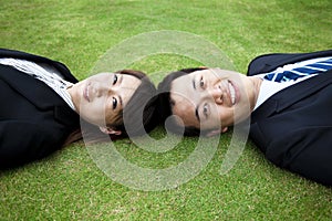 Young couple and lay on the grass