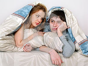 Young couple laying in bed together