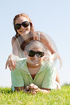 Young Couple lie down on grass