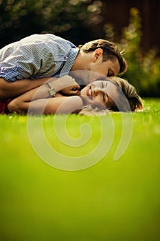 Young couple lie on the lawn