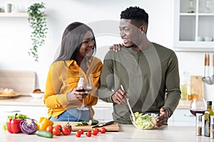 Young Couple Lifestyle. Happy Black Man And Woman Spending Time In Kitchen