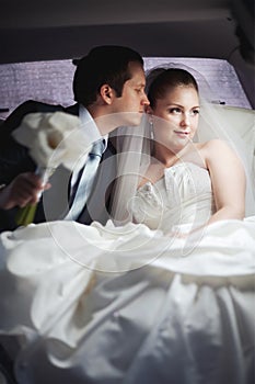 Young couple in limo kissing