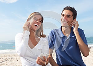 Young couple listening to music from the phone