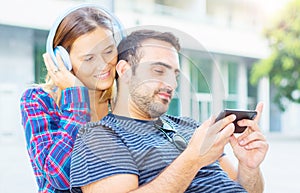 Young couple listening and watching music on the phone