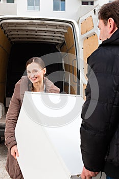 Young couple loading a moving truck