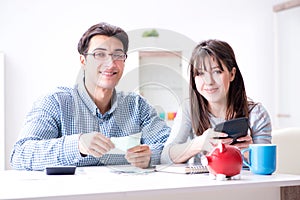 The young couple looking at family finance papers