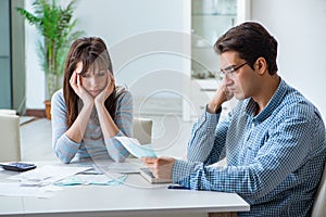 The young couple looking at family finance papers