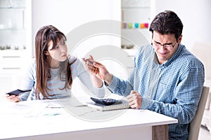 The young couple looking at family finance papers