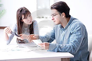 The young couple looking at family finance papers