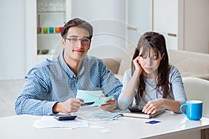 The young couple looking at family finance papers