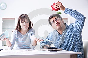 The young couple looking at family finance papers